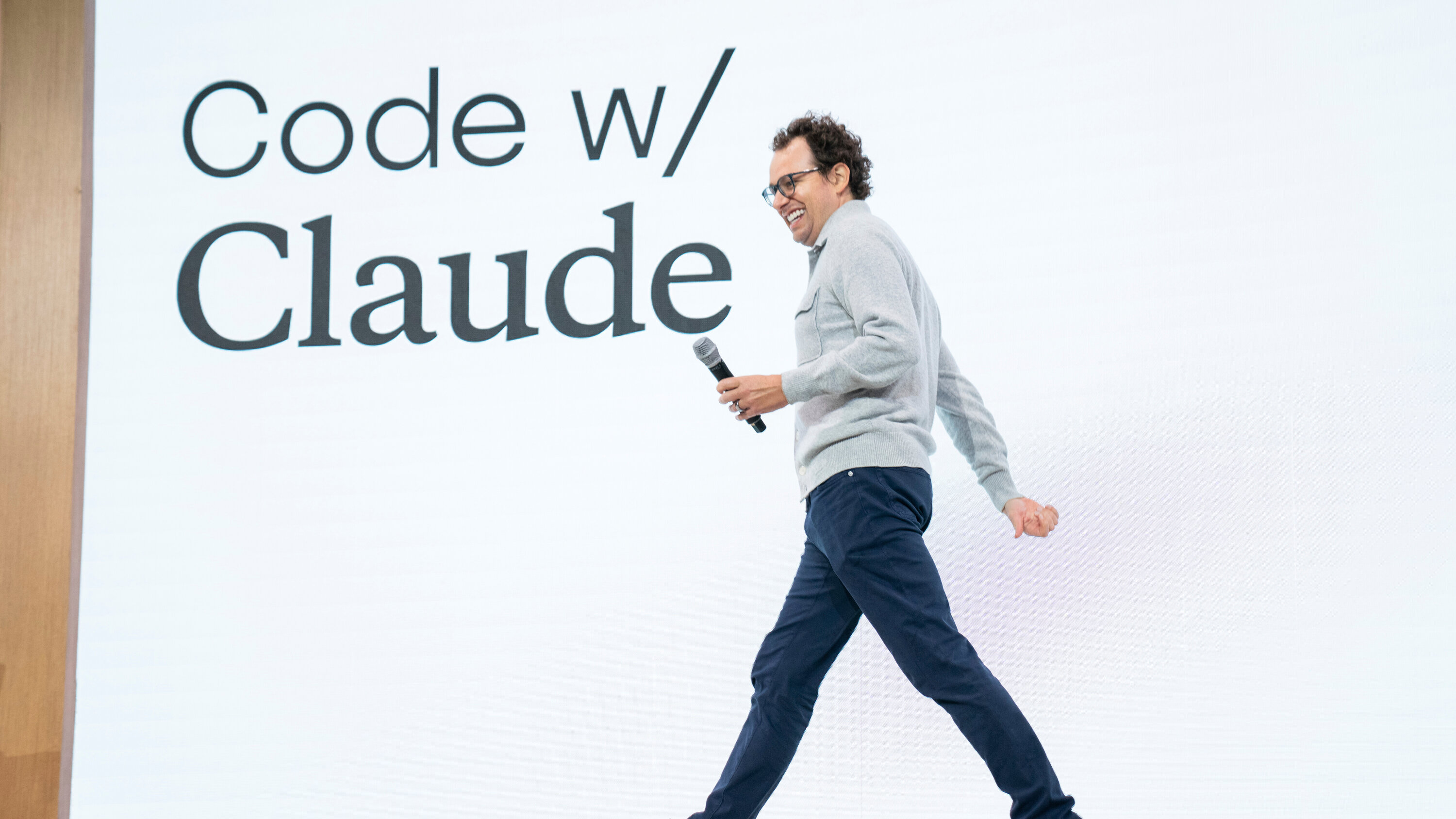 Boris Cherny walking on stage in front of a Code w/ Claude banner